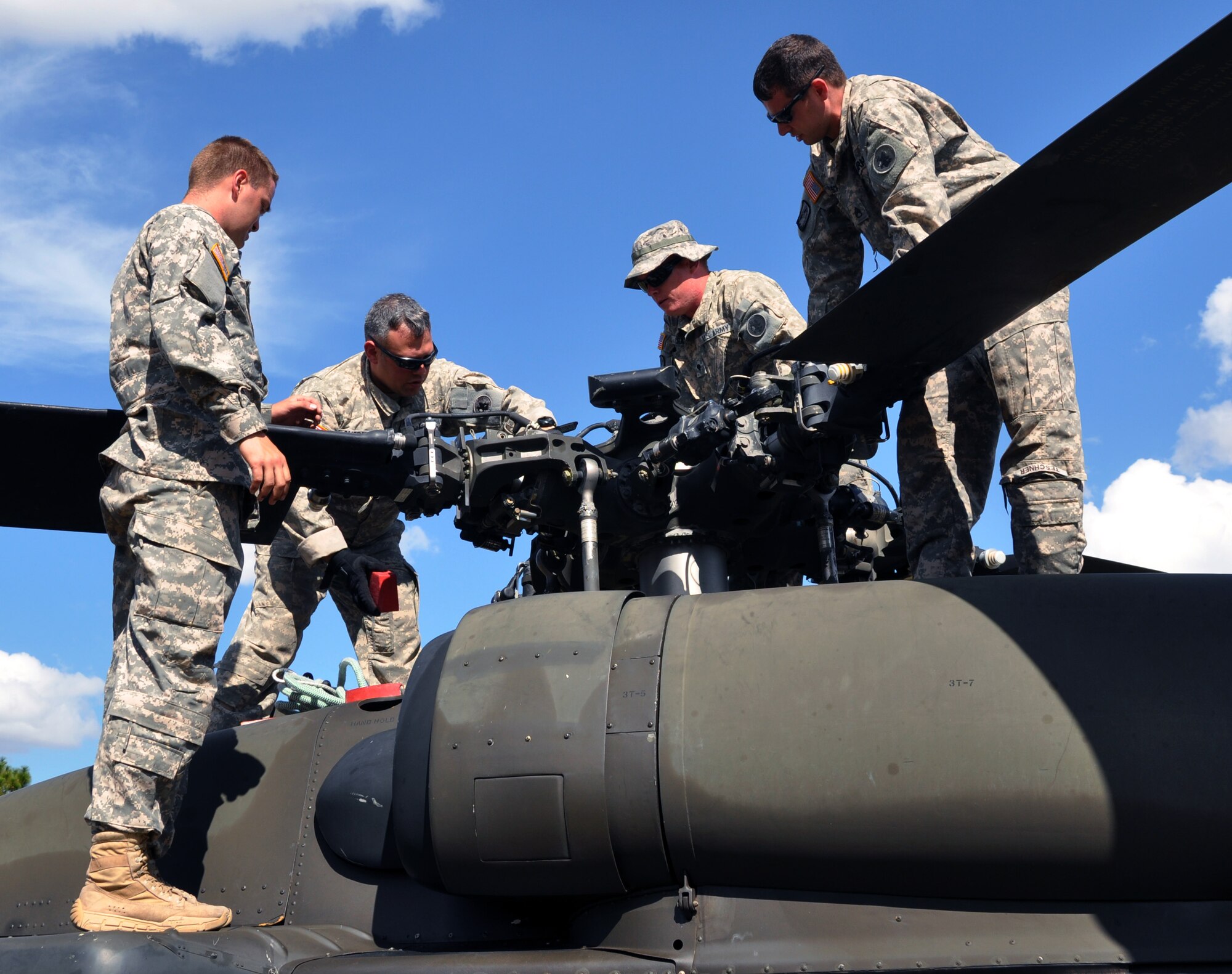 Members of Joint Task Force-Bravo's Downed Aircraft Recovery Team prepare a UH-60 helicopter for slingloading during a personnel and downed aircraft recovery exercise in Honduras, Feb. 4, 2014.  The purpose of the exercise was to validate the unit's ability to immediately support a personnel recovery in the event of a downed aircraft. (U.S. Air Force photo by Capt. Zach Anderson)
