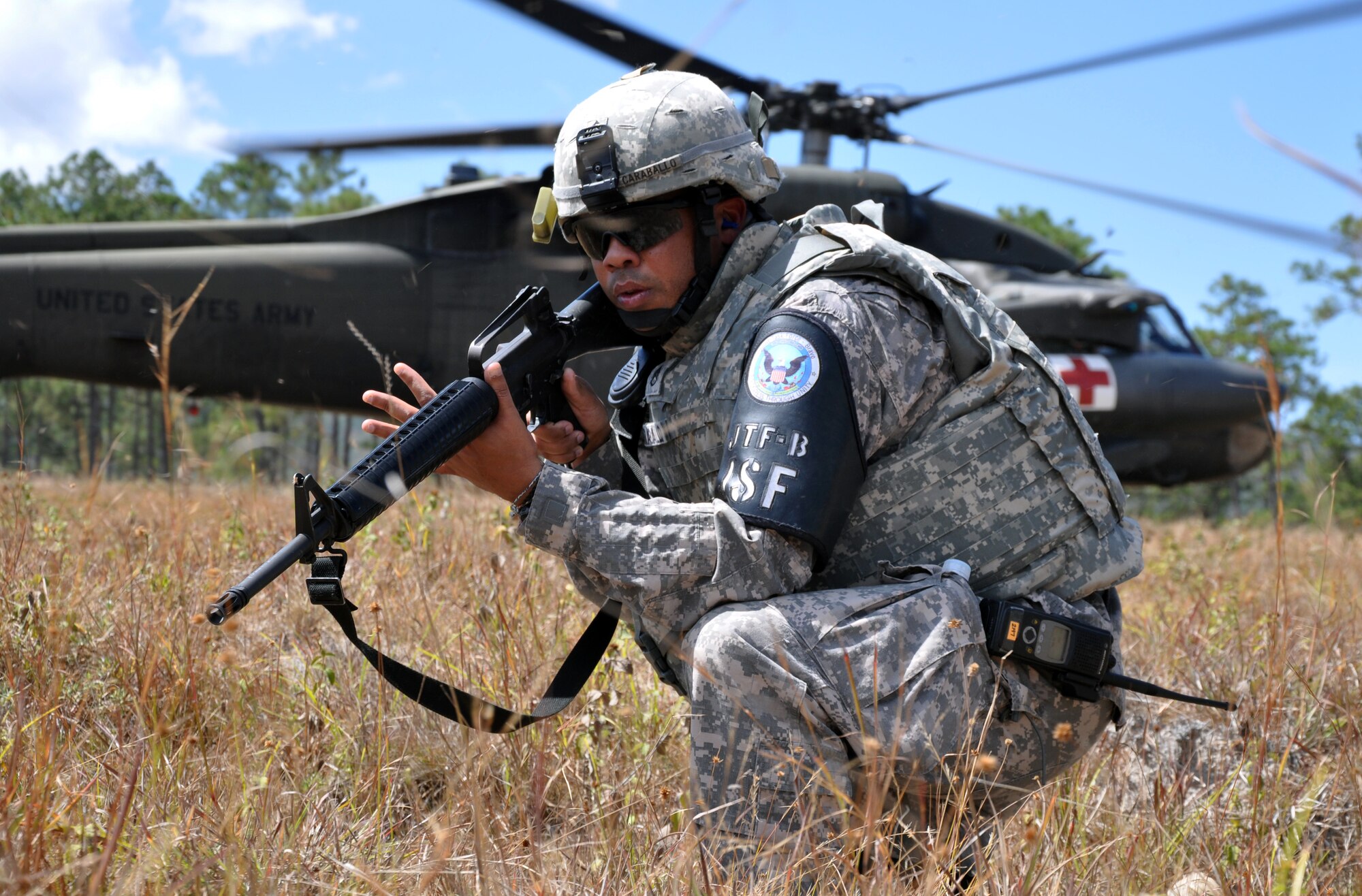 U.S. Army Staff Sgt. Hector Caraballo, Joint Security Forces Squadron, provides security during a medical evacuation of a simulated injured aircrew member during a personnel and downed aircraft recovery exercise in Honduras, Feb. 4, 2014.  The purpose of the exercise was to validate the unit's ability to immediately support a personnel recovery in the event of a downed aircraft. (U.S. Air Force photo by Capt. Zach Anderson)