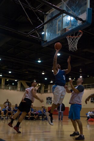 Javerrick Austin, 99th Security Forces Squadron power forward, shoots a lay-up during an intramural basketball game against the 547th Intelligence Squadron at the Warrior Fitness Center Feb. 3, 2014, at Nellis Air Force Base, Nev. A total of 20 teams between two divisions are participating in the 2014 intramural basketball season. The 99th SFS won the game 60-49. (U.S. Air Force photo by Senior Airman Christopher Tam)
