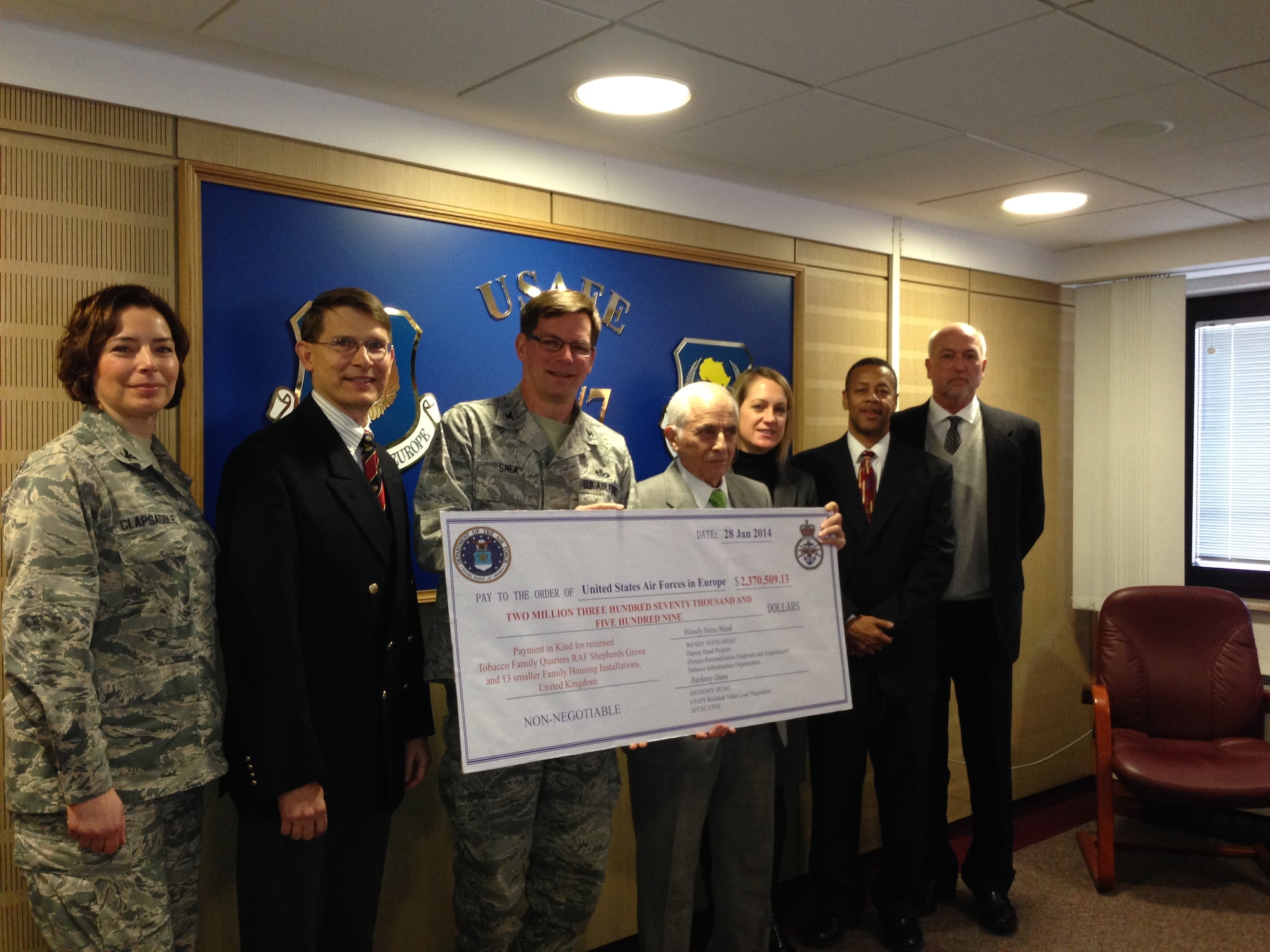 RAMSTEIN AIR BASE, Germany -- Members of the Air Force Civil Engineer Center Europe Division are joined by members of the U.S. Air Forces in Europe headquarters staff as they give Col. Stephen E. Shea (third from left) a presentation check for $2.4 million. The money was recouped in a residual value settlement for military housing in the United Kingdom and will help fund future construction, maintenance, repairs and environmental compliance projects at USAFE installations. (U.S. Air Force photo)