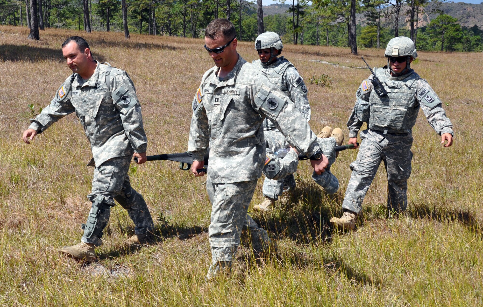 Members of Joint Task Force-Bravo's Joint Security Forces Squadron and 1-228th Aviation Regiment practice the medical evacuation of a simulated injured aircrew member during a personnel and downed aircraft recovery exercise in Honduras, Feb. 4, 2014.  The purpose of the exercise was to validate the unit's ability to immediately support a personnel recovery in the event of a downed aircraft. (U.S. Air Force photo by Capt. Zach Anderson)