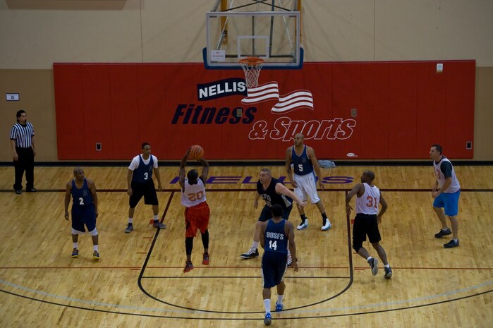 Jamar Wright, 547th Intelligence Squadron shooting guard, shoots the ball during an intramural basketball game against the 99th Security Forces Squadron at the Warrior Fitness Center Feb. 3, 2014, at Nellis Air Force Base, Nev. Teams are divided into two different divisions -- the East and West made up of 10 teams each. The top 10 teams with the best record will play in the playoffs. The 99th SFS defeated the 547th IS 60-49. (U.S. Air Force photo by Senior Airman Christopher Tam)