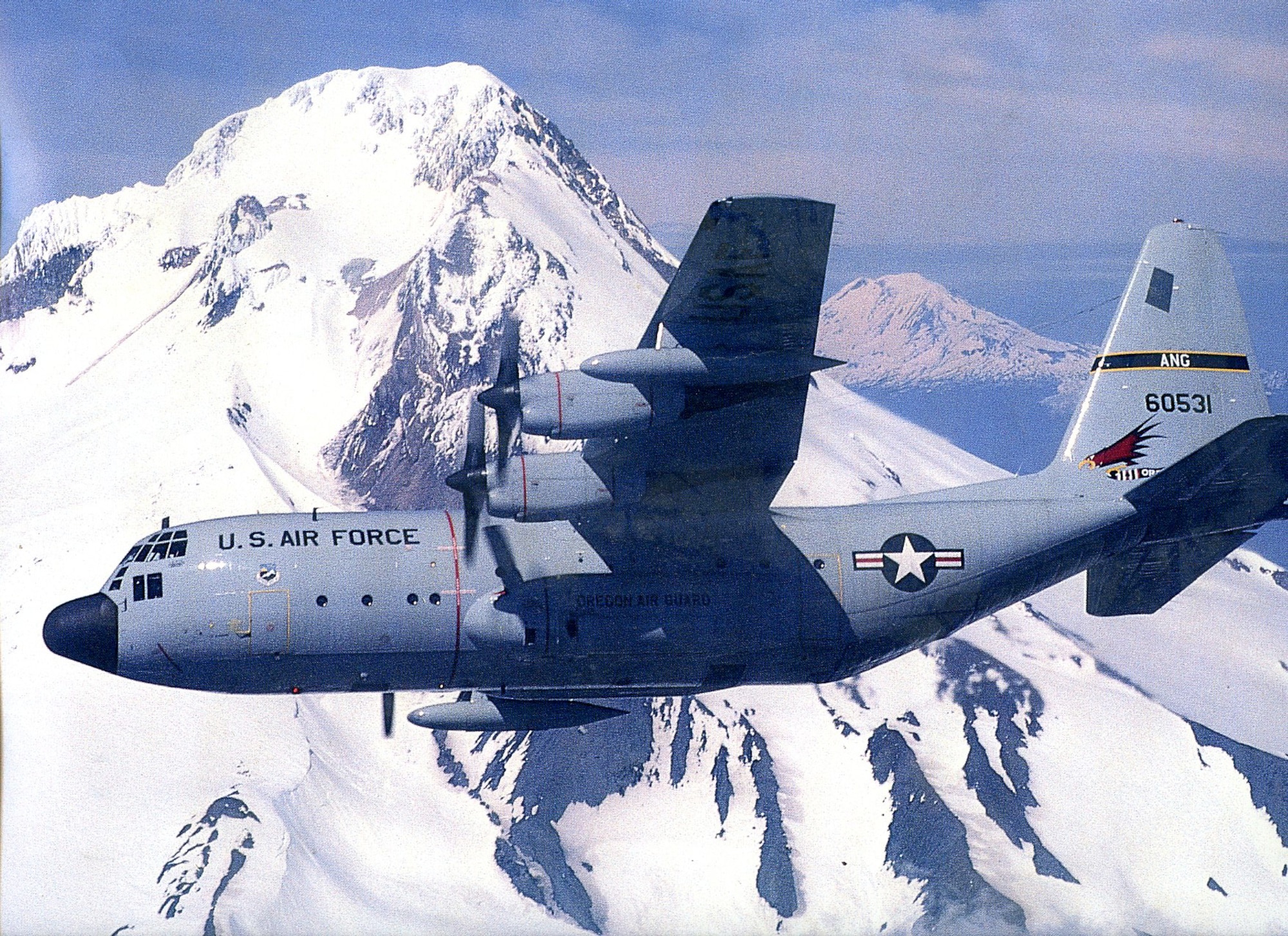 An Oregon Air National Guard C-130 Hercules transport aircraft flys over the Cascade Mountain Range in Oregon. (History photo from 142nd Fighter Wing History Office)
