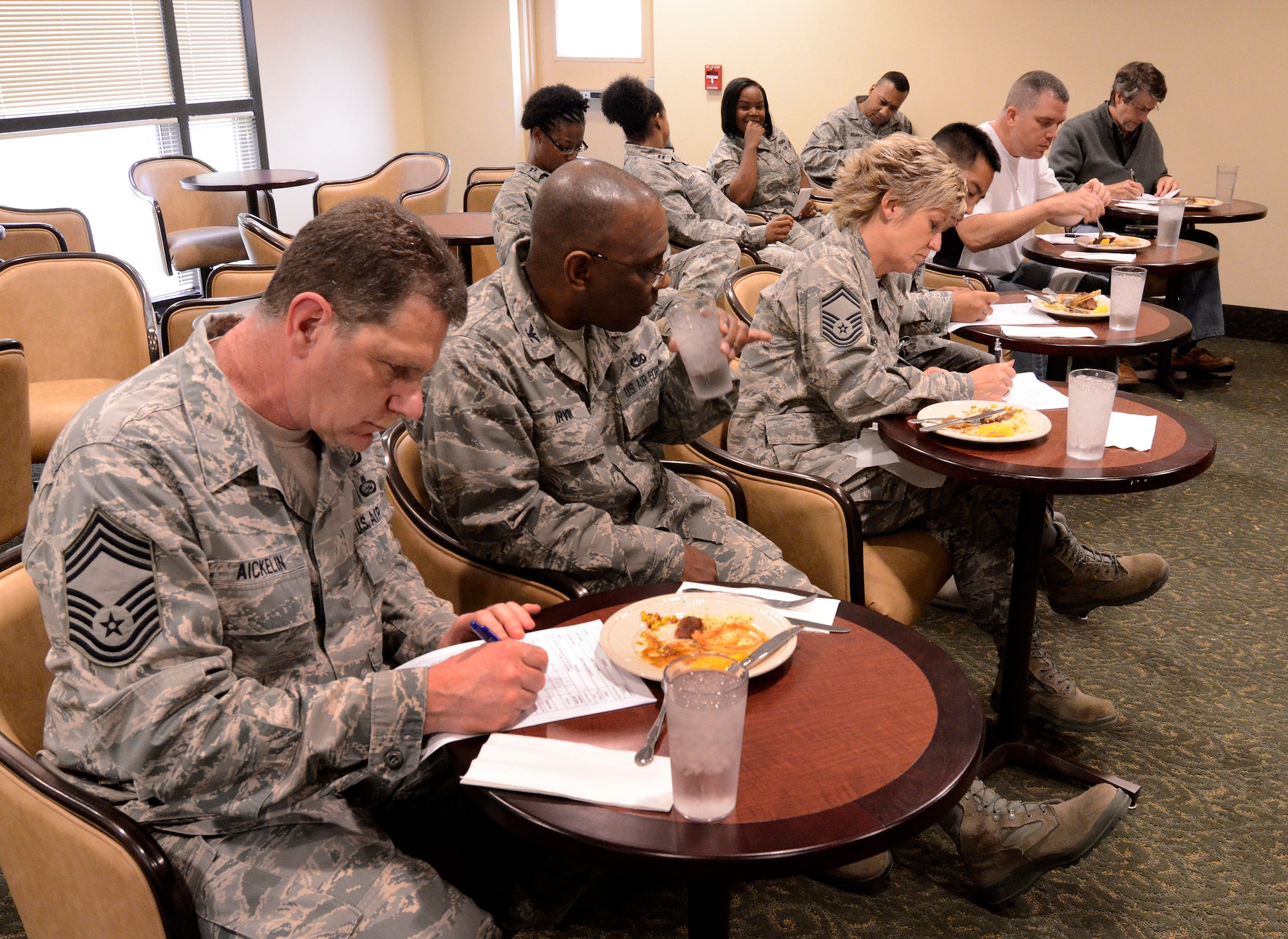 Col. Marshall Irvin, 94th Mission Support Group commander, Capt. Robert Mayes of the 94th Security Forces Squadron, Capt. Jamison De la Pena of the 94th Communications Squadron, Chief Master Sgt. Ronald A. Aickelin of the 622nd Regional Support Group, Senior Master Sgt. Joy Hughes of 94th Education and Training and Mr. Ken Williams of 94th Civil Engineering, judge dishes prepared by Consolidated Club Chefs Mike Medford and David (Chef Dave) D 'Amour during the first taste test for the Air Force Reserve Command Top Chef Competition Oct. 28. (U.S. Air Force photo/Brad Fallin)