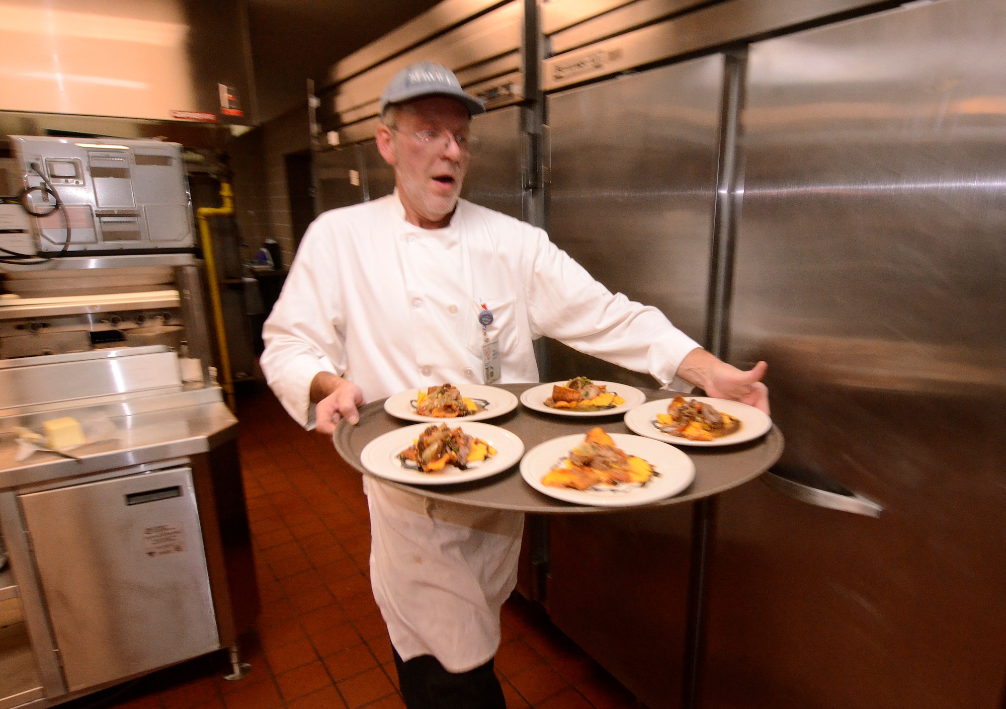 David D 'Amour, Dobbins’ Consolidated Club chef, serves short ribs braised in fresh-squeezed orange juice, onion, garlic, cinnamon, raisons and morocco flavor with cumin on a bed of sweet potato puree during the first taste test for the Air Force Reserve Command Top Chef Competition Oct. 28. (U.S. Air Force photo/Brad Fallin)