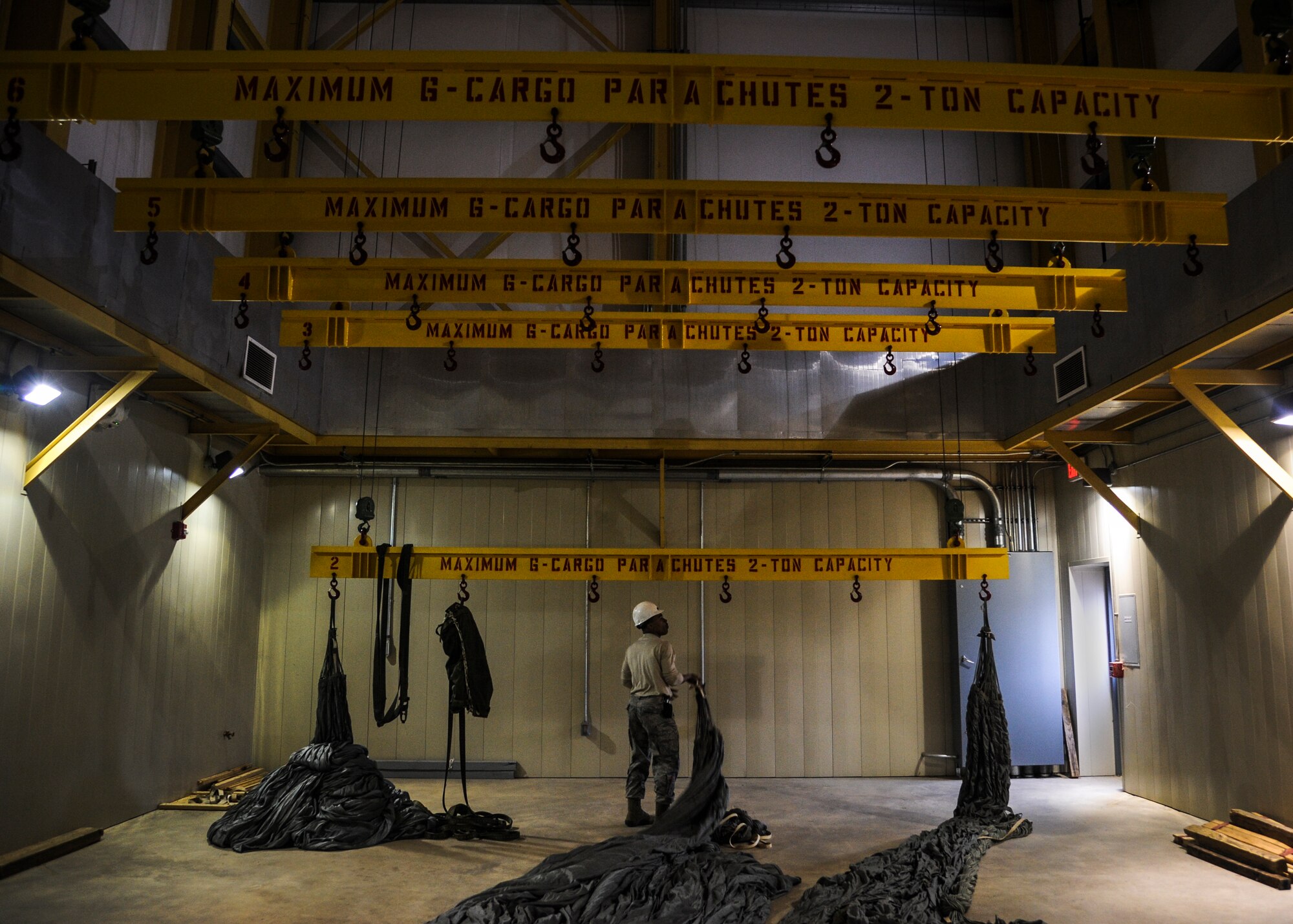 Staff Sgt. Victor Boyd, 19th Logistics Readiness Squadron aerial delivery supervisor, checks to see if a parachutes is still damp Feb. 4, 2014, at Little Rock Air Force Base, Ark. The cargo platform parachutes are required to hang in a heated room for at least 72 hours to ensure that they have been dried. (U.S. Air Force photo by Airman 1st Class Harry Brexel)
