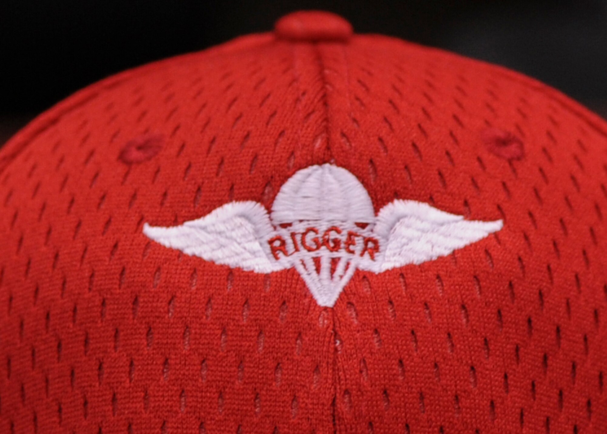 Lead riggers have the unique privilege of wearing red hats while working. The hat signifies that they have experience and are the most knowledgeable in equipping cargo platforms. (U.S. Air Force photo by Airman 1st Class Harry Brexel)