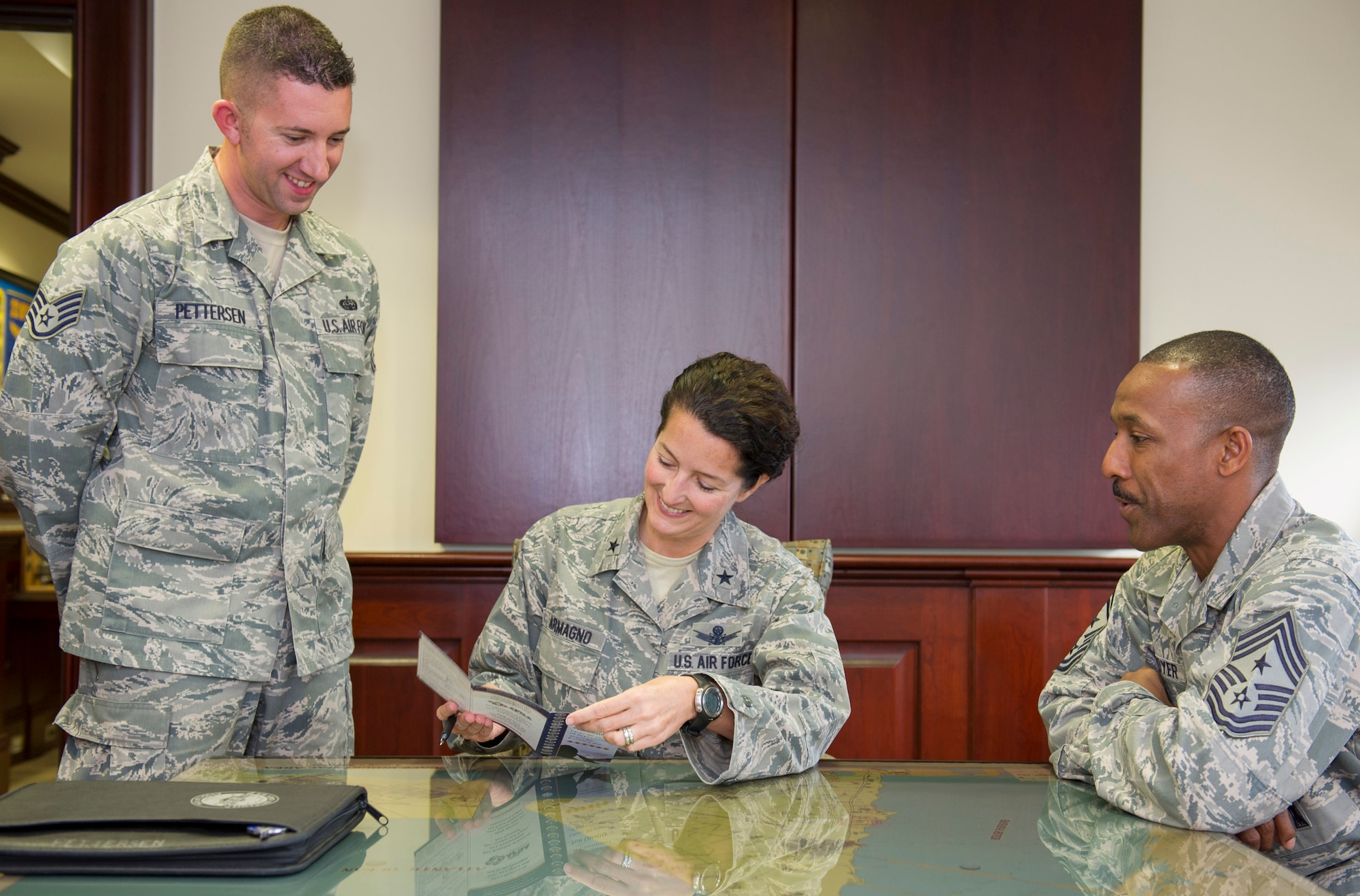 Brig. Gen. Nina Armagno, 45th Space Wing commander, becomes an honorary member of the Air Force Sergeants Association Chapter 0557 Jan. 8, 2014. Staff Sgt. Brandon Pettersen, AFSA representative, and Chief Master Sgt. Herman Moyer, 45th Space Wing command chief, look on. (U.S. Air Force photo/Matthew Jurgens)