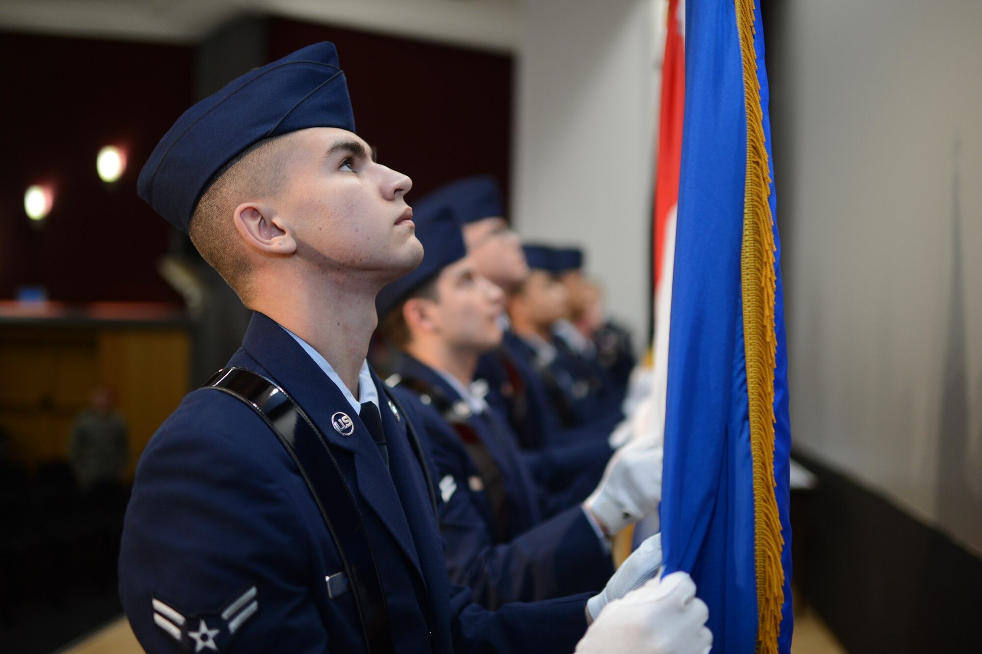 U.S. Air Force Airman 1st Class Michael McBride, 606th Air Control Squadron data maintenance technician from Orlando, Fla., posts the U.S. Air Force flag at an honor guard graduation and induction ceremony after a week-long training, on Spangdahlem Air Base Jan. 31, 2014. At the graduation, the honor guard trainees performed ceremonial honors which were learned and practiced over the week. (U.S. Air Force photo by Senior Airman Gustavo Castillo/Released)