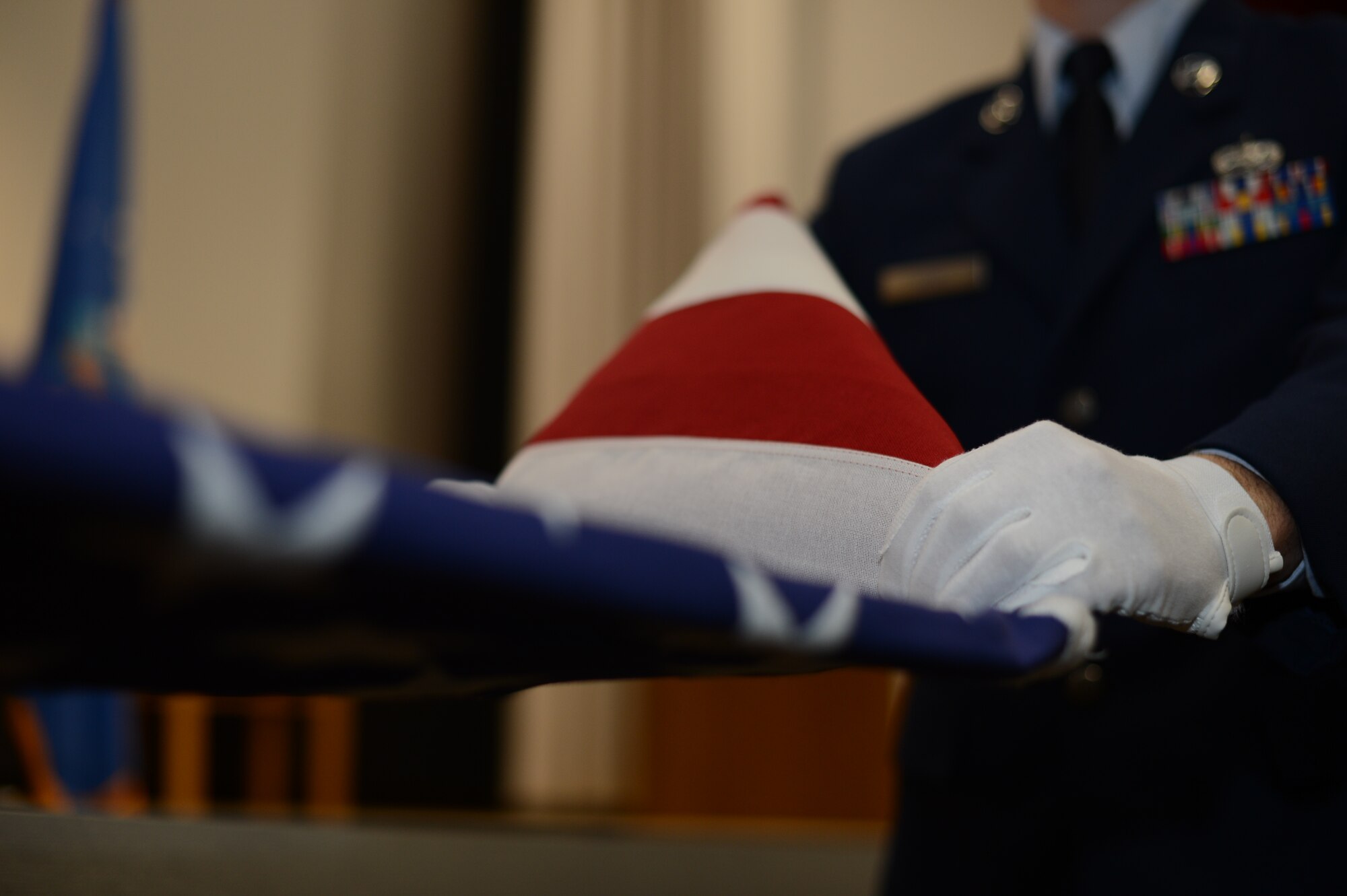 U.S. Air Force Staff Sgt. Richard Hiort, 52nd Component Maintenance Squadron avionics technician from Tewksburry, Mass., practices a ceremonial flag folding before his honor guard graduation, at Spangdahlem Air Base Jan. 31, 2014. The week-long trainings hope to bring in double the amount of honor guard members previously and will be held semi-annually. (U.S. Air Force photo by Senior Airman Gustavo Castillo/Released)