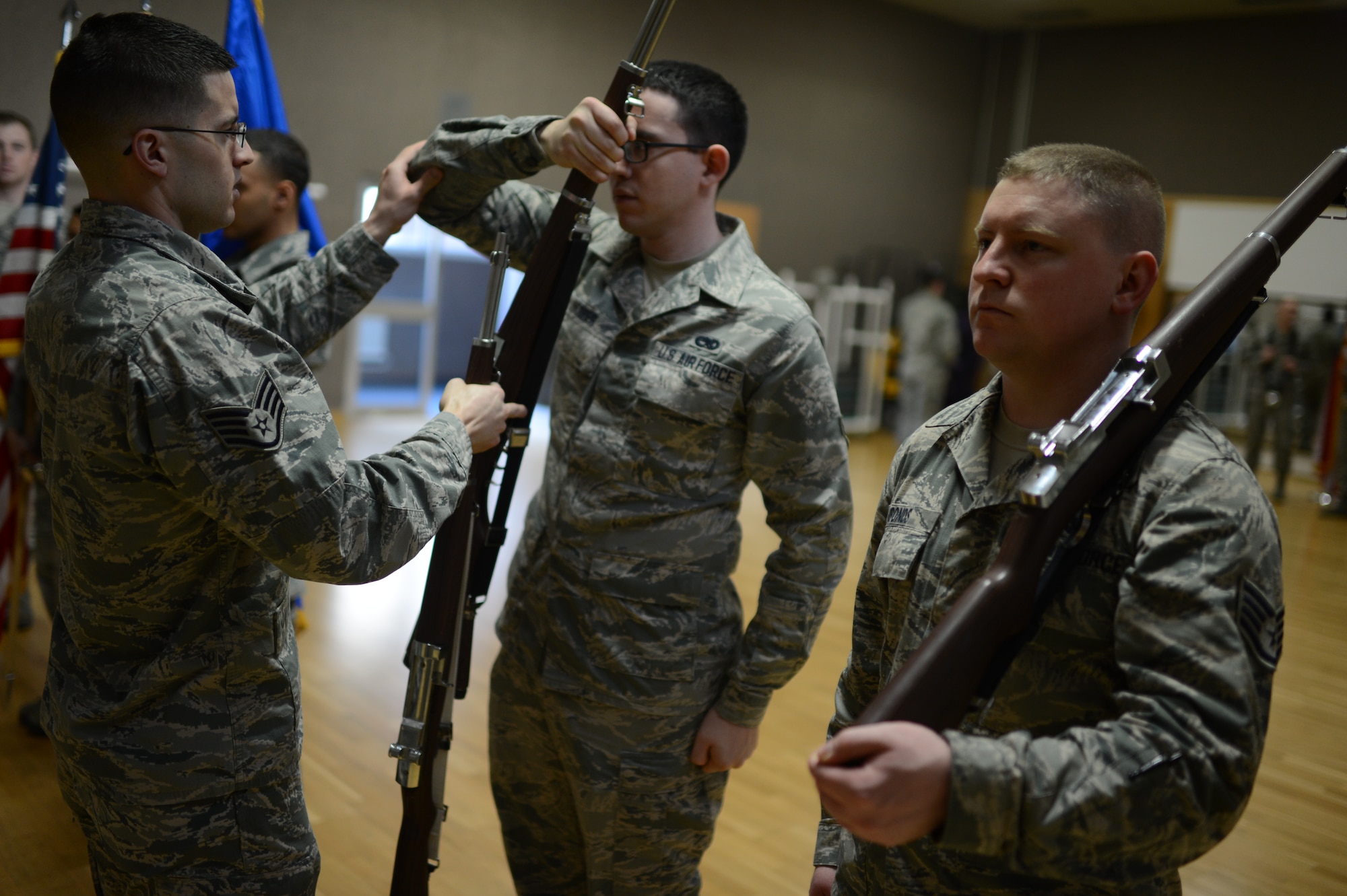 U.S. Air Force Staff Sgt. Gavin Saiz, 52nd Fighter Wing Honor Guard bravo flight chief, from Peoria, Ariz., instructs Airmen on proper rifle movement techniques during an honor guard training week, at Spangdahlem Air Base Jan. 29, 2014. The Airmen were tested throughout the week on knowledge and movements learned throughout the course of the week before becoming fully qualified guardsmen. (U.S. Air Force photo by Senior Airman Gustavo Castillo/Released)