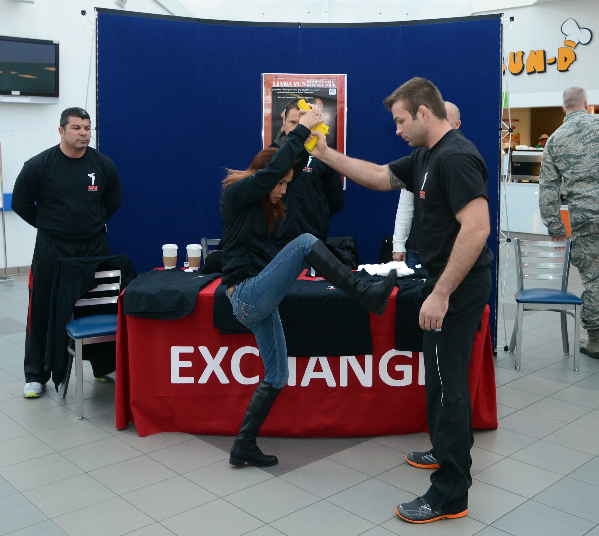 Linda Vu, women’s self-defense trainer, demonstrates different ways to fend off an armed attacker Feb. 4, 2014, at the BXtra on RAF Mildenhall, England. Vu teaches fitness and is an accomplished martial artist. Vu visited RAF Mildenhall on her European women’s self-defense tour and gave a seminar on self-defense at the Northside Fitness Center. (U.S.  Air Force photo by Airman 1st Class Kelsey Waters/Released)