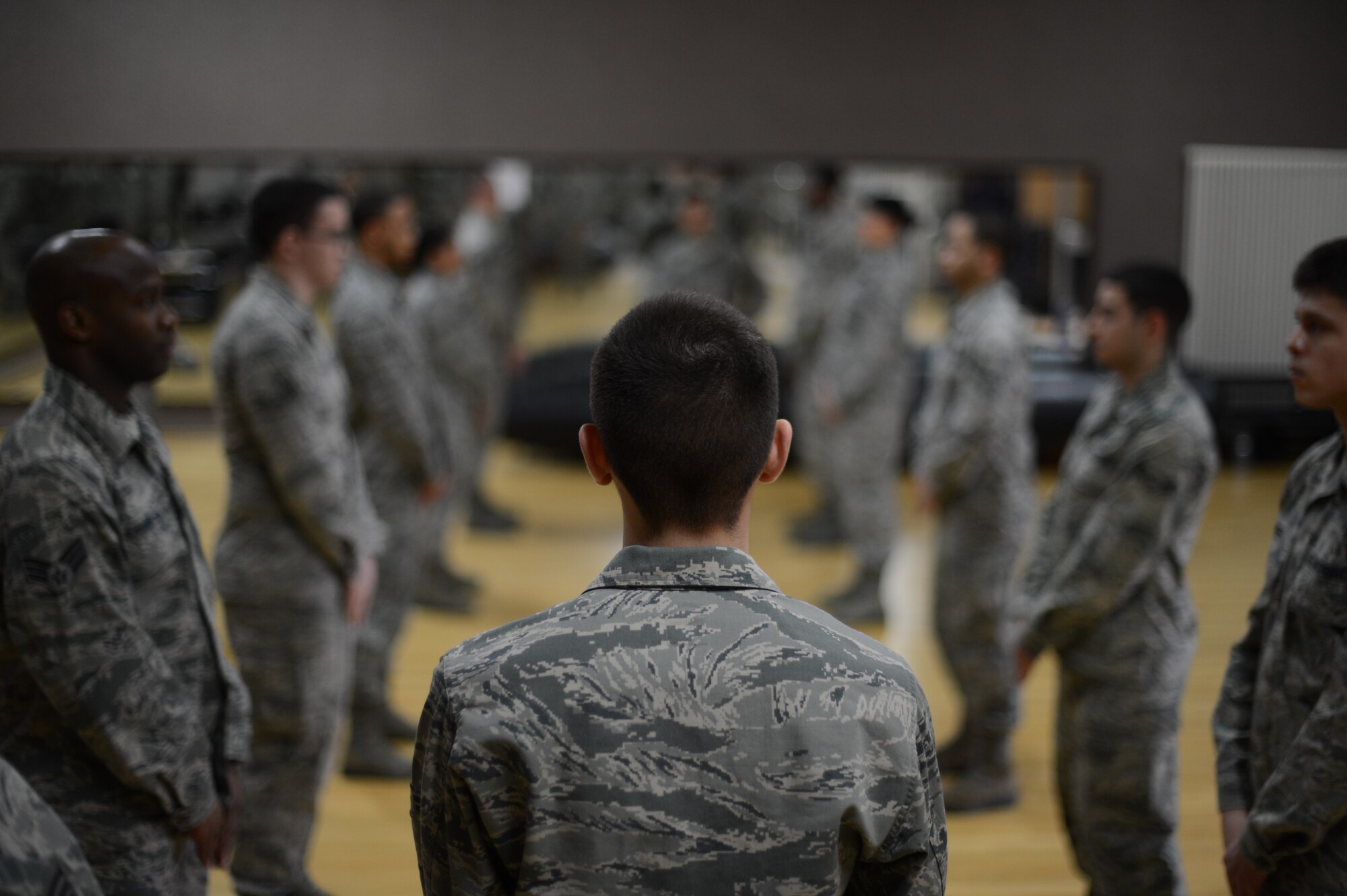 Airmen stand in formation practicing facing movements during an honor guard training week at Spangdahlem Air Base, Jan. 27, 2014. Throughout the week, honor guard trainees spent more than 40 hours practicing drill and ceremony techniques. (U.S. Air Force photo by Senior Airman Gustavo Castillo/Released)