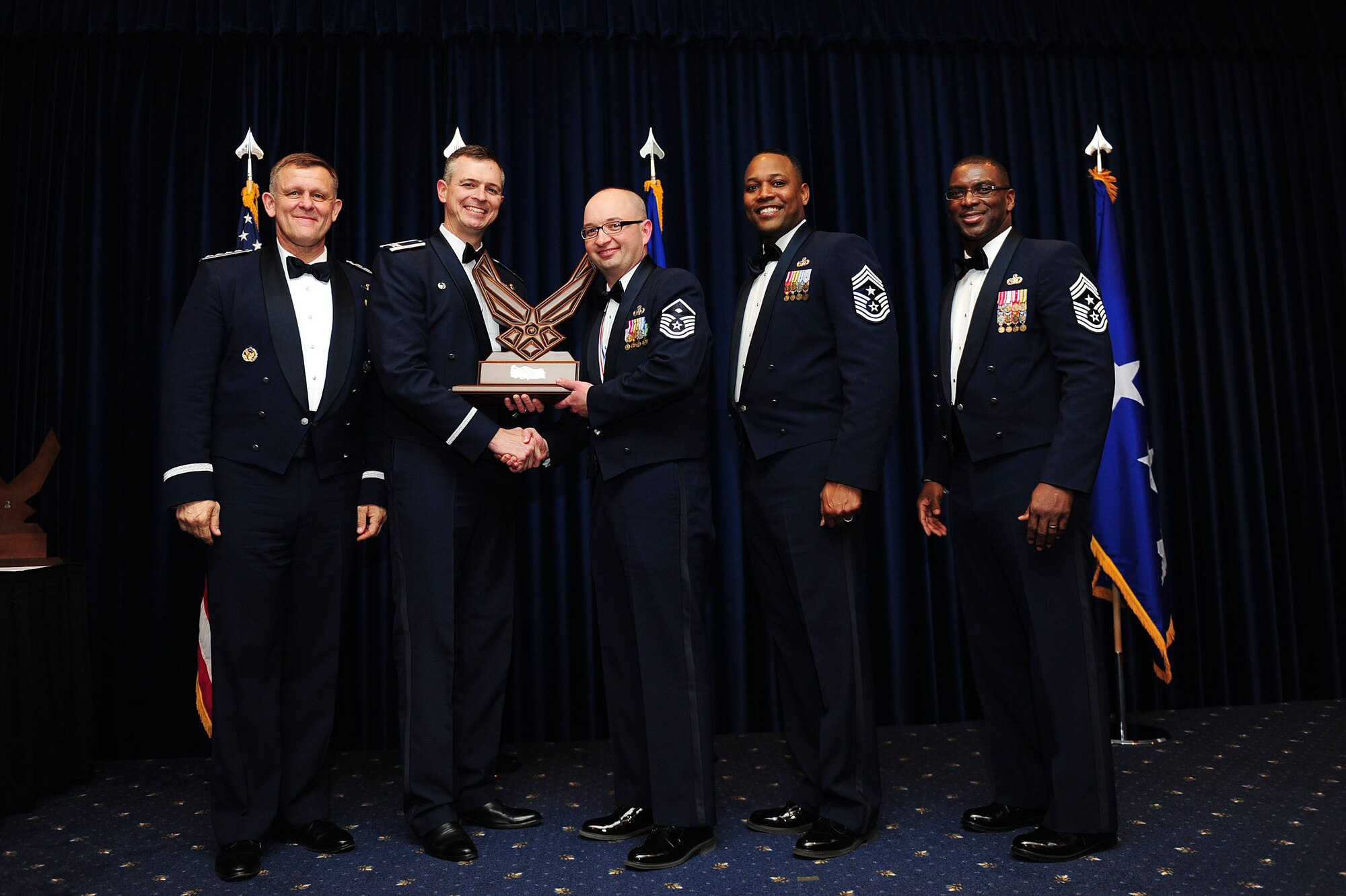 Master Sgt. Matthew Cluver, 39th Medical Group, receives the 39th Air Base Wing First Sergeant of the Year award from Col. Craig Wills, 39th Air Base Wing commander, during the 2013 Annual Awards Banquet Feb. 4, 2014, at Incirlik Air Base, Turkey. Also there for the award presentations were Gen. Frank Gorenc (left), U.S. Air Forces in Europe and U.S. Air Forces Africa commander, Chief Master Sgt. Anthony Johnson, 39th ABW command chief, and Chief Master Sgt. James Davis (right), USAFE-AFAFRICA command chief. (U.S. Air Force photo by Airman 1st Class Nicole Sikorski/Released) 