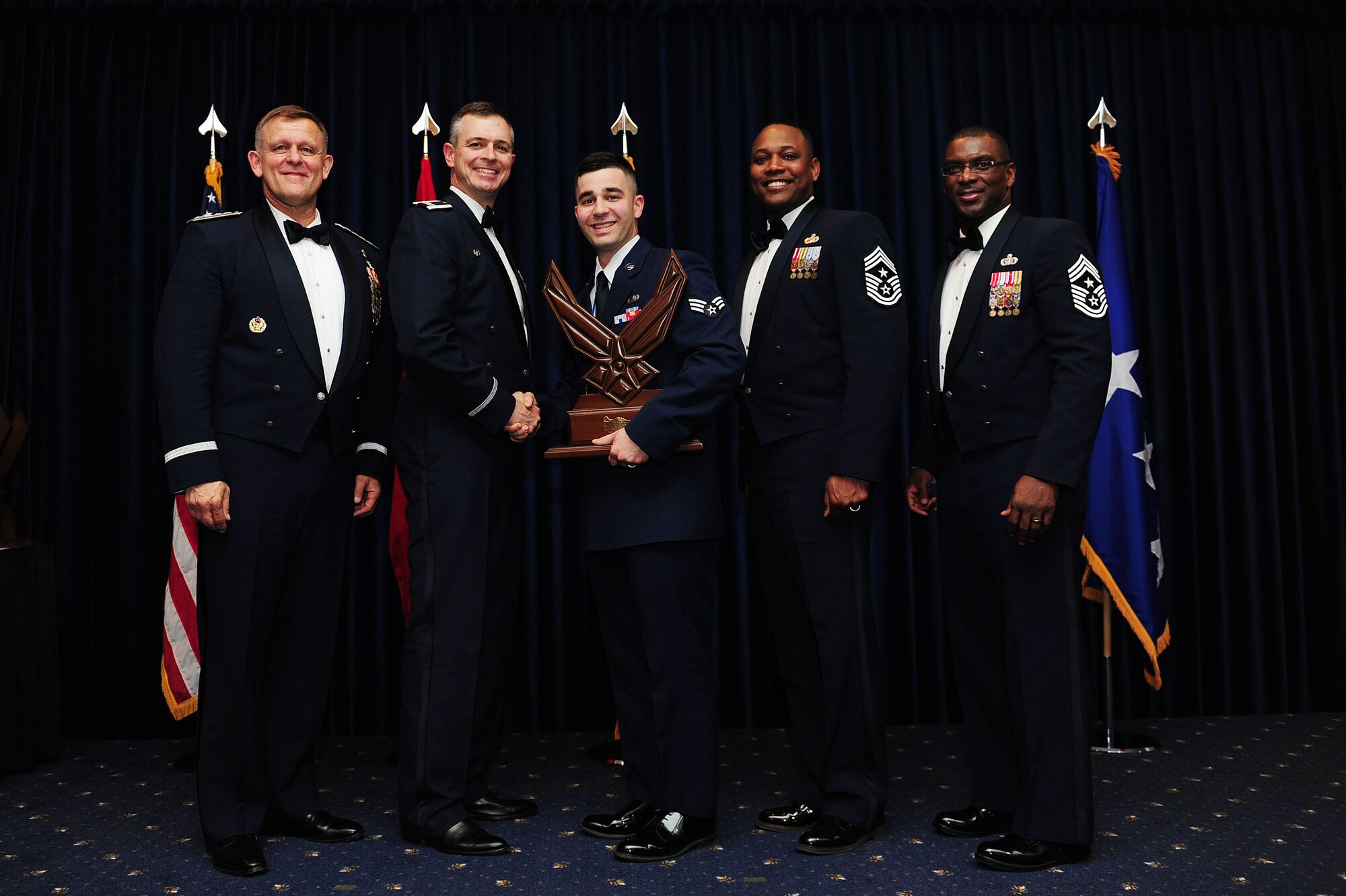 Senior Airman Erik Johnson, 39th Contracting Squadron, receives the 39th Air Base Wing Airman of the Year award from Col. Craig Wills, 39th Air Base Wing commander, during the 2013 Annual Awards Banquet Feb. 4, 2014, at Incirlik Air Base, Turkey. Also there for the award presentations were Gen. Frank Gorenc (left), U.S. Air Forces in Europe and U.S. Air Forces Africa commander, Chief Master Sgt. Anthony Johnson, 39th ABW command chief, and Chief Master Sgt. James Davis (right), USAFE-AFAFRICA command chief. (U.S. Air Force photo by Airman 1st Class Nicole Sikorski/Released) 