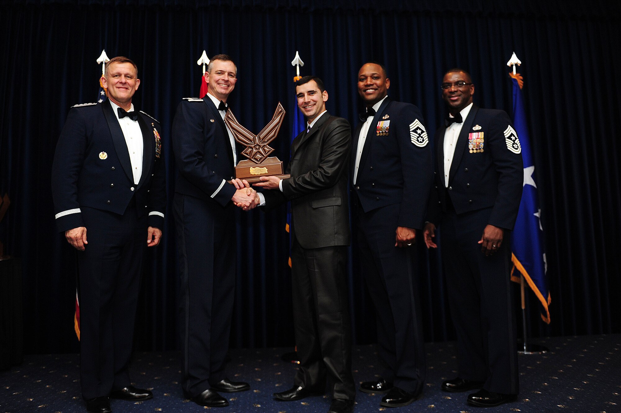 Joseph Dyson, 39th Force Support Squadron, receives the 39th Air Base Wing Civilian of the Year Category II award from Col. Craig Wills, 39th Air Base Wing commander, during the 2013 Annual Awards Banquet Feb. 4, 2014, at Incirlik Air Base, Turkey. Also there for the award presentations were Gen. Frank Gorenc (left), U.S. Air Forces in Europe and U.S. Air Forces Africa commander, Chief Master Sgt. Anthony Johnson, 39th ABW command chief, and Chief Master Sgt. James Davis (right), USAFE-AFAFRICA command chief. (U.S. Air Force photo by Airman 1st Class Nicole Sikorski/Released)