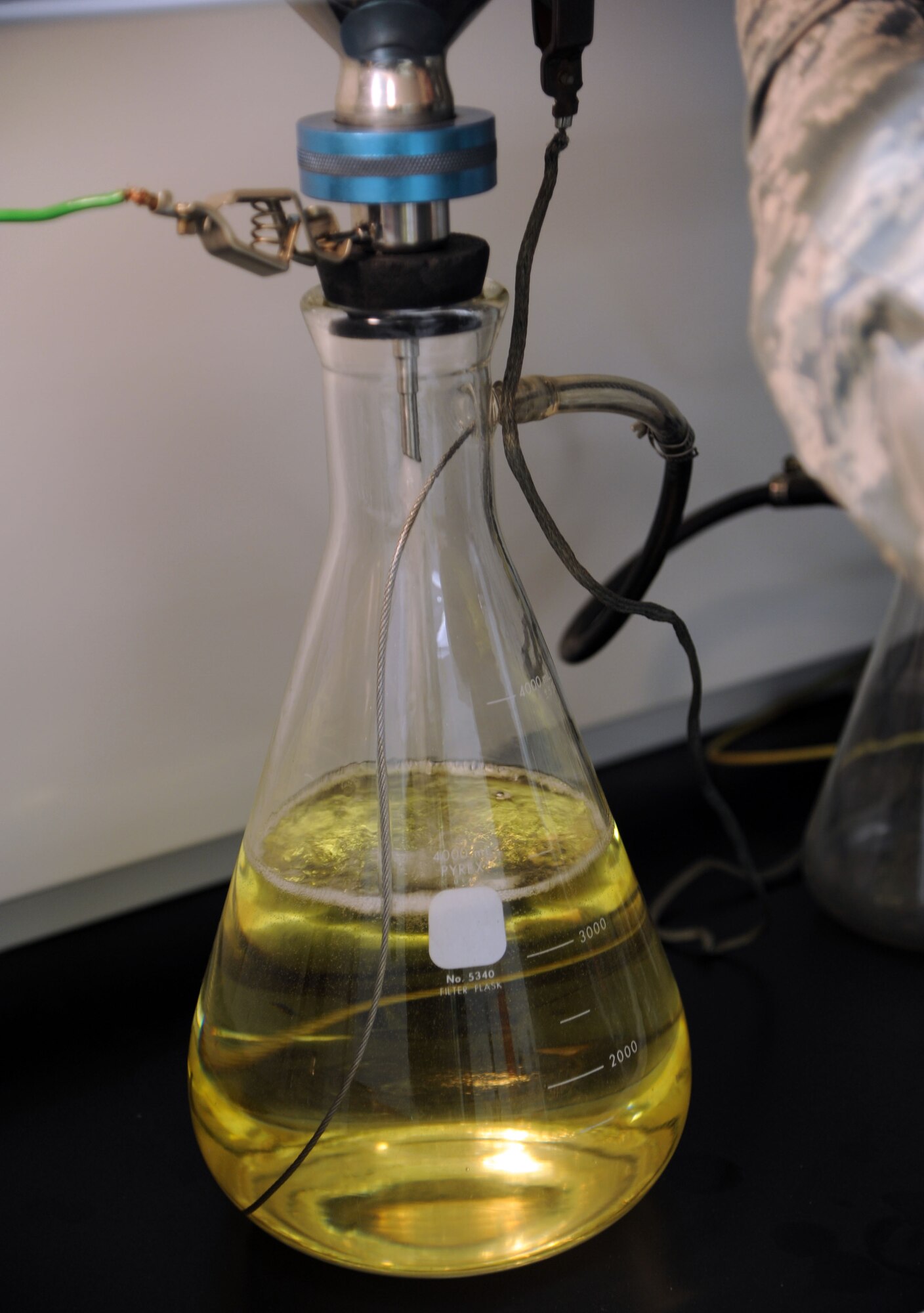 ALTUS AIR FORCE BASE, Okla. – U.S. Air Force Senior Airman Zakkary Wiest, 97th Logistics Readiness Squadron fuels apprentice, conducts a test on a fuel sample Jan. 31, 2014. The pictured sample is attached to a vacuum to remove excess air from the beaker while the test is being performed. (U.S. Air Force photo by Airman 1st Class J. Zuriel Lee/Released)