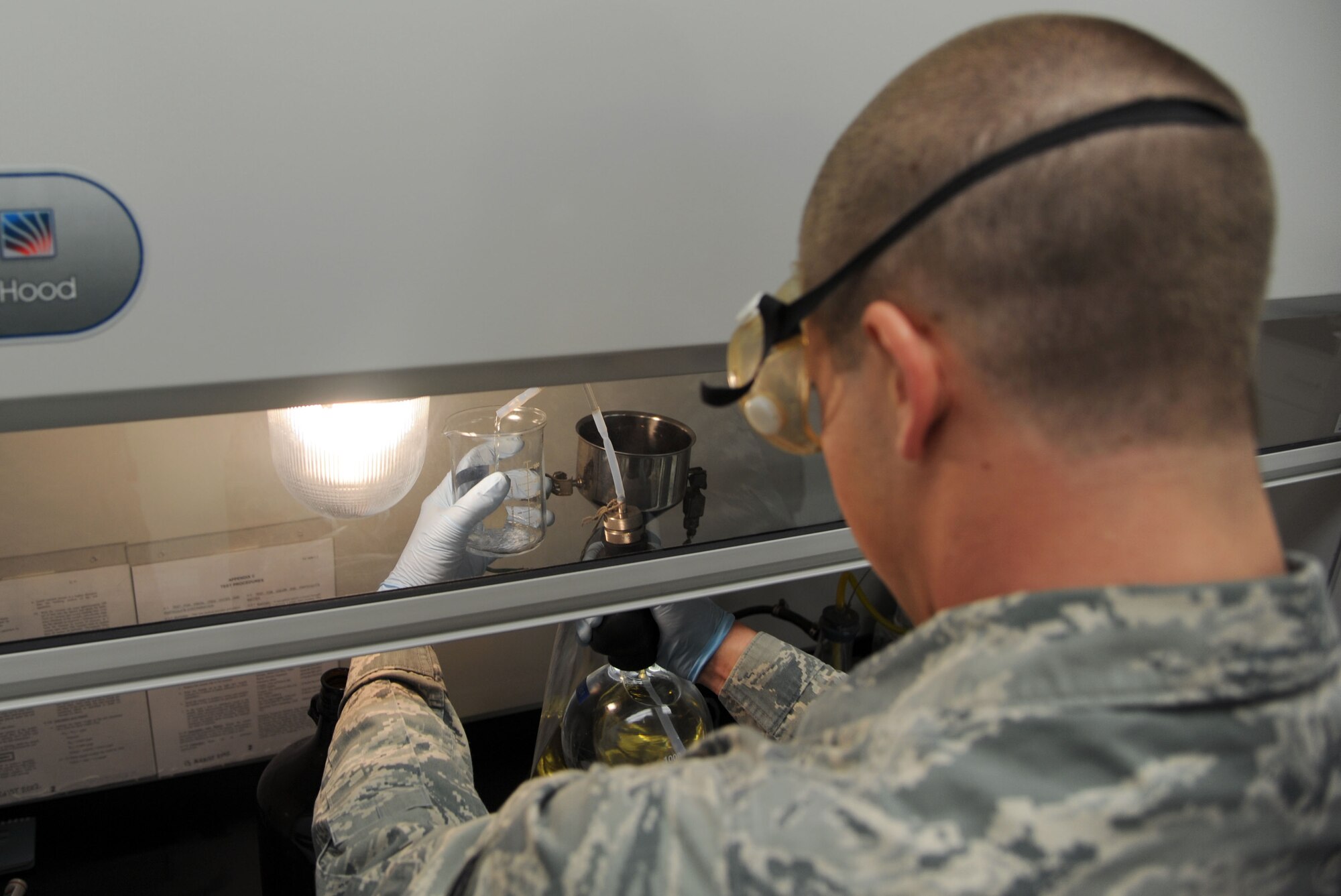 ALTUS AIR FORCE BASE, Okla. – U.S. Air Force Senior Airman Zakkary Wiest, 97th Logistics Readiness Squadron fuels apprentice, finishes a fuel sample test Jan. 31, 2014. The samples have to undergo many tests to ensure the fuel is clean, dry and useable by the aircraft. (U.S. Air Force photo by Airman 1st Class J. Zuriel Lee/Released)