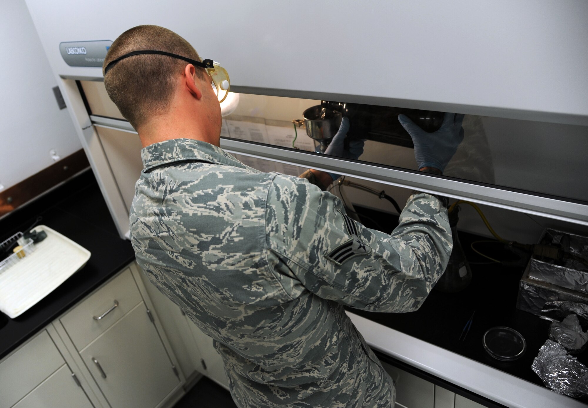 ALTUS AIR FORCE BASE, Okla. – U.S. Air Force Senior Airman Zakkary Wiest, 97th Logistics Readiness Squadron fuels apprentice, pours a fuel sample for testing Jan. 31, 2014. The samples undergo many tests to ensure that the fuel is clean, dry and useable by the aircraft. (U.S. Air Force photo by Airman 1st Class J. Zuriel Lee/Released)