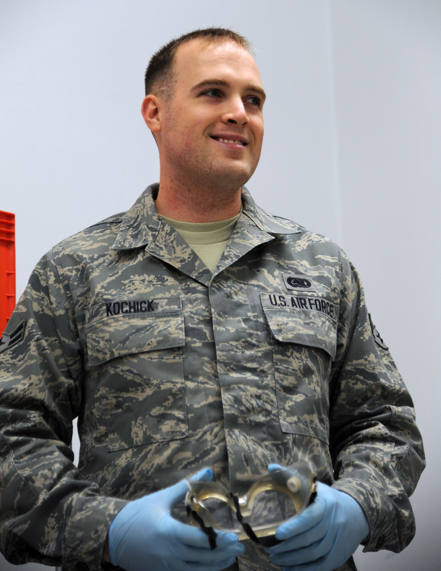 ALTUS AIR FORCE BASE, Okla. – U.S. Air Force Airman 1st Class Damon Kochick, 97th Logistics Readiness Squadron fuels apprentice, prepares to work in the fuels lab by donning protective glasses and latex gloves Jan. 31, 2014. Airmen who work in the fuels lab test fuel samples to ensure standards set by Air Force regulations are met. (U.S. Air Force photo by Airman 1st Class J. Zuriel Lee/Released)