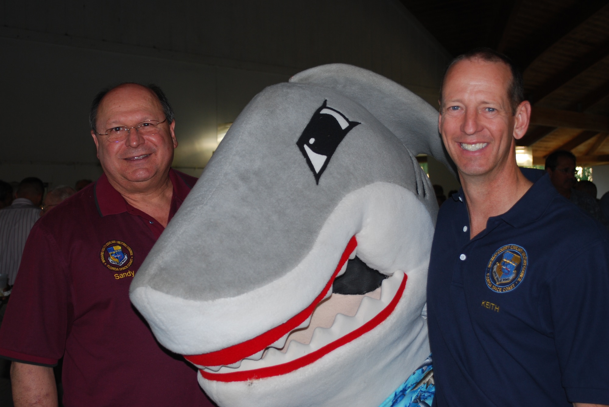 Sandy Sanderson, vice chairman of the CivMil board of trustees, left, was named Commander’s Civilian Military Community Relations Council's 2013 member of the year. Sandy poses with "Snark," the 45th Space Wing mascot, and Keith Houston, former Chairman of the local CivMil Council. (Photo by Chris Calkins)