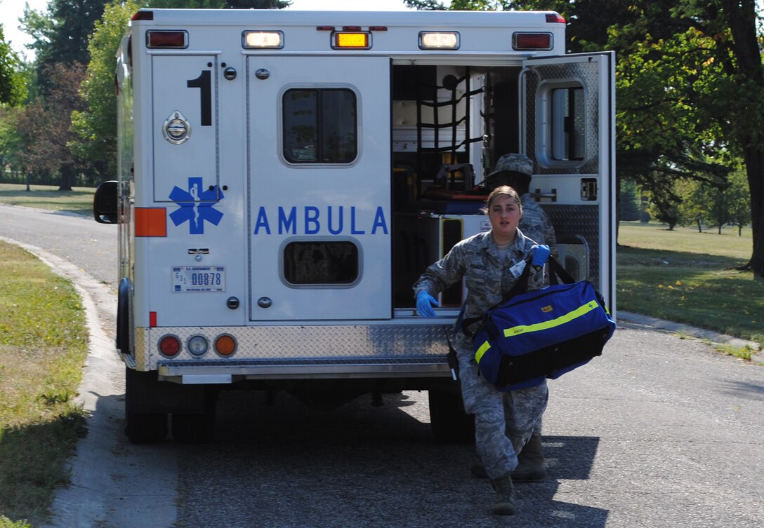 Senior Airman Amanda Schaefer, 319th Medical Operations Squadron aerospace medical technician, rushes to help volunteers pretending to suffer from injuries sustained during an active shooter exercise Aug. 16, 2013, on Grand Forks Air Force Base, N.D.  Schafer was named the base’s Warrior of the Week for the first week of February 2014. (U.S. Air Force photo/Staff Sgt. Luis Loza Gutierrez)  
