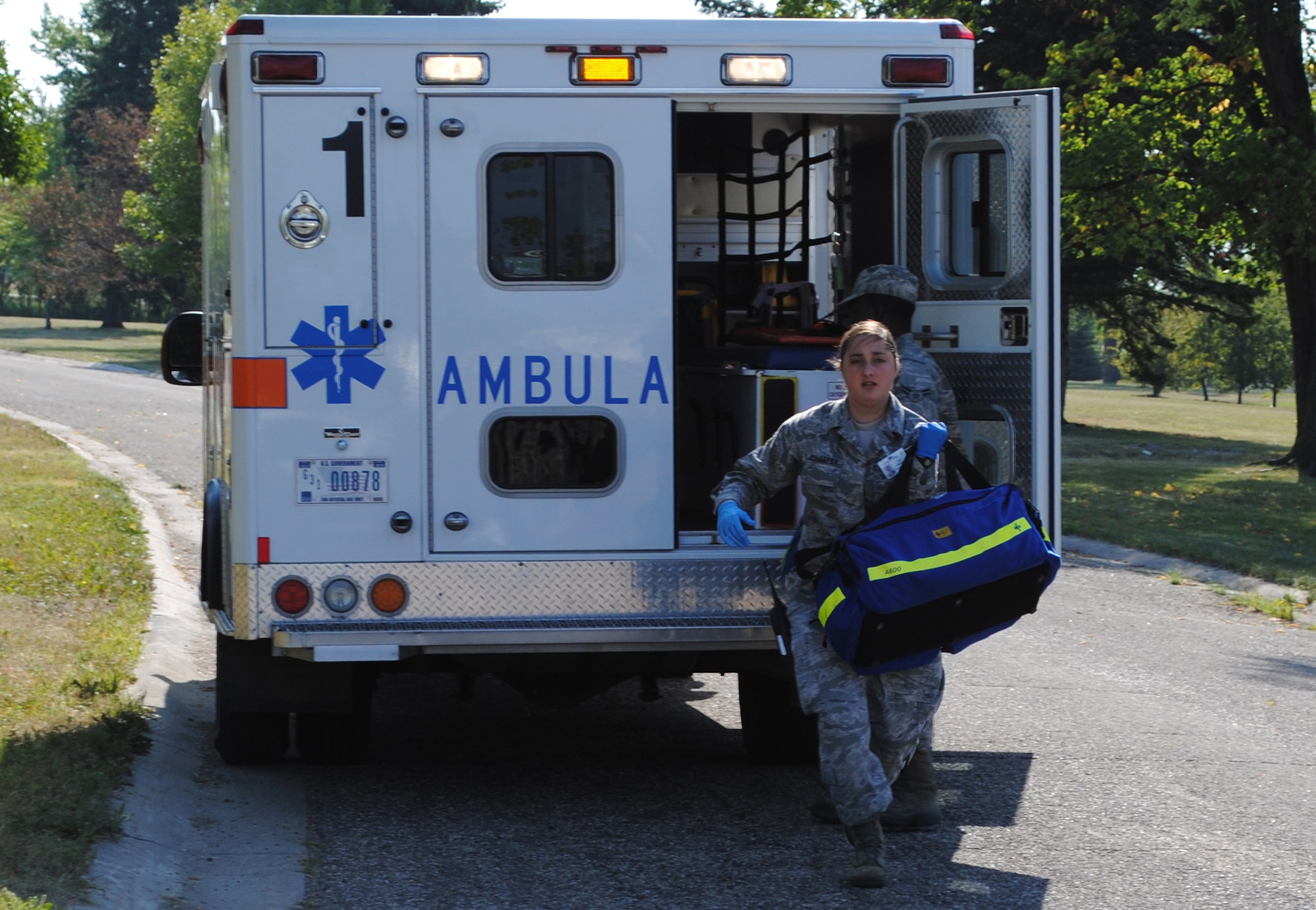 Senior Airman Amanda Schaefer, 319th Medical Operations Squadron aerospace medical technician, rushes to help volunteers pretending to suffer from injuries sustained during an active shooter exercise Aug. 16, 2013, on Grand Forks Air Force Base, N.D.  Schafer was named the base’s Warrior of the Week for the first week of February 2014. (U.S. Air Force photo/Staff Sgt. Luis Loza Gutierrez)  

