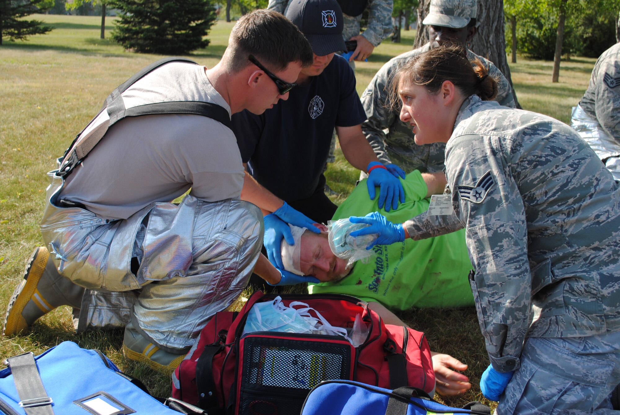 (At right) Senior Airman Amanda Schaefer, 319th Medical Operations Squadron aerospace medical technician,  gives directions to fellow first responders from the base fire department on how treat  a volunteer pretending to suffer from an head injury during an active shooter exercise Aug. 16, 2013, on Grand Forks Air Force Base, N.D.  Schafer was named the base’s Warrior of the Week for the first week of February 2014. (U.S. Air Force photo/Staff Sgt. Luis Loza Gutierrez) 
