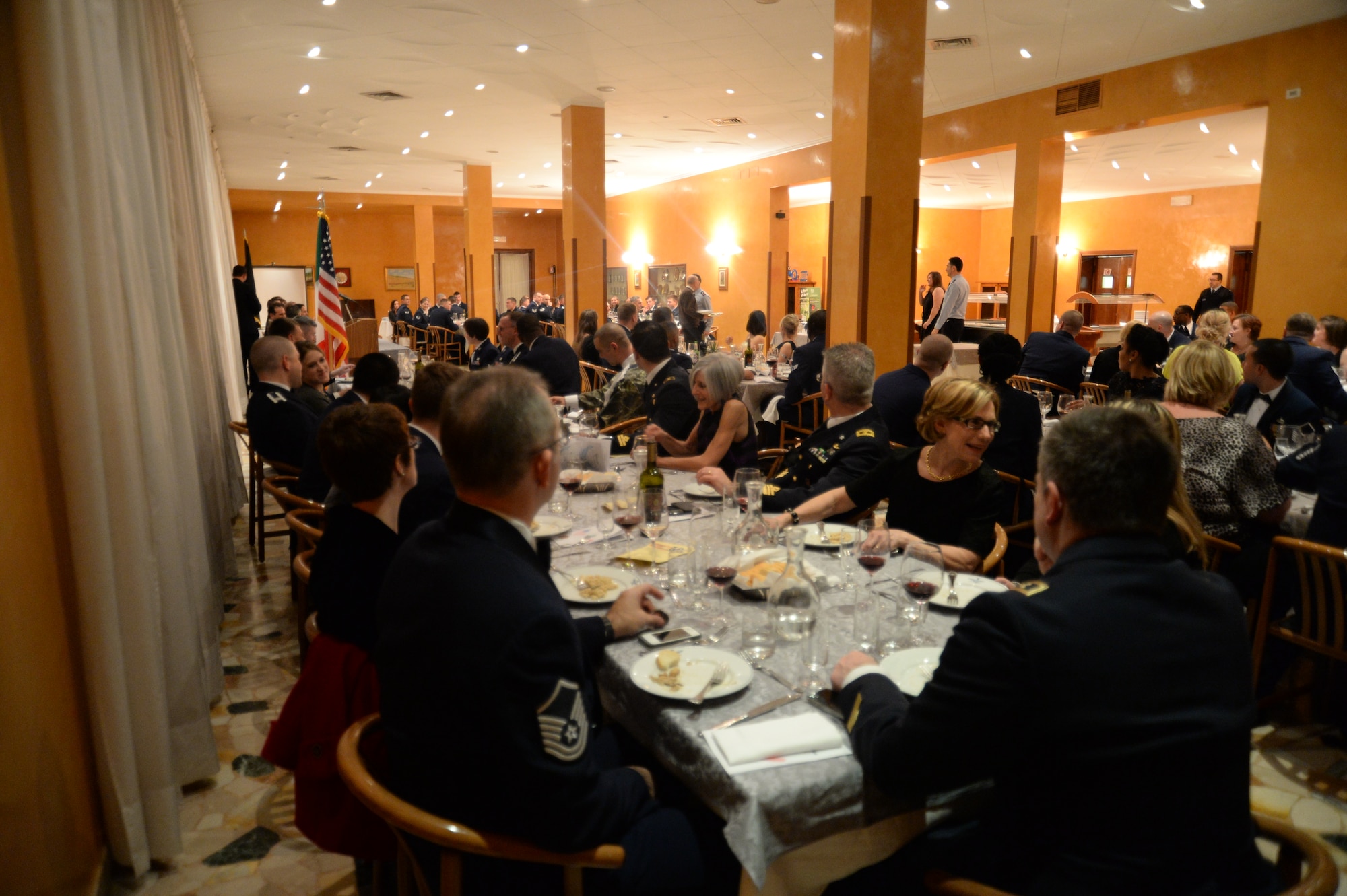 Italian and American Air Force Airmen and their guests view the dining out banquet at the Officer’s Club at Ghedi Air Base, Italy, Jan. 31, 2014. The history of the dining out and its customs dates back to U.S. Air Force Gen. Hap Arnold’s “Wing-dings.” (U.S. Air Force photo by Staff Sgt. Joe W. McFadden / Released)