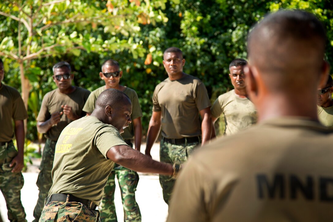 U.S. Marine Corps Sgt. Maxwell McCants, center, demonstrates techniques to Maldivian marines during U.S. Marine Corps Martial Arts Program training in Maafilaafushi, Maldives, Feb. 3, 2014. McCants is assigned to Mobile Training Team, U.S. Marine Corps Forces, Pacific. The noncommissioned officer development program provides professional military and cultural exchanges, allowing forces to train in unfamiliar settings and learn different tactics, techniques and procedures.