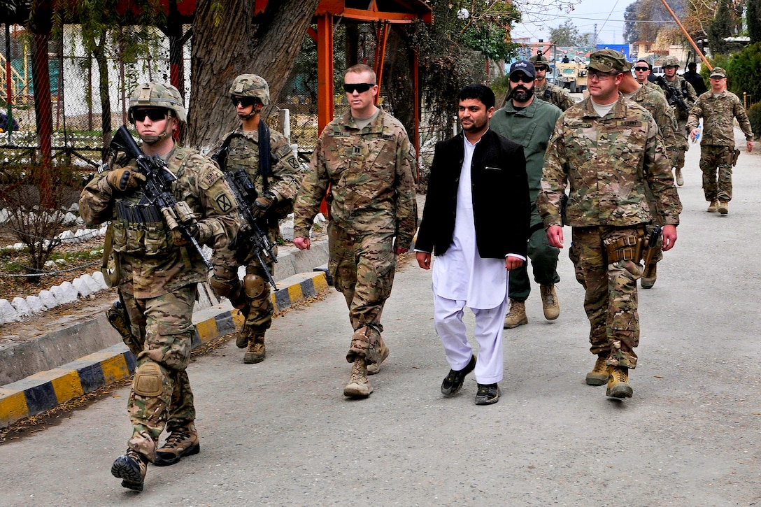 U.S. soldiers enter the Afghan national police headquarters in Jalalabad, Afghanistan, Feb. 3, 2014. The soldiers are assigned to a security force advise and assist team attached to the 10th Mountain Division's 4th Brigade Combat Team.