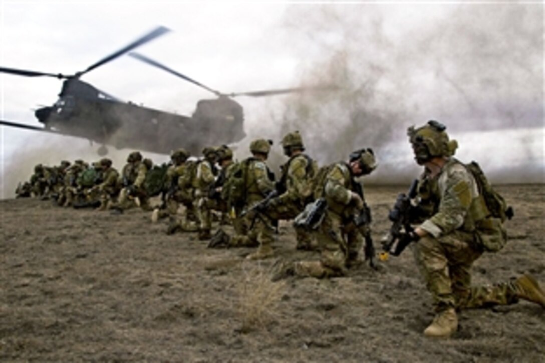 Army Rangers prepare to leave their live-fire training site in a CH-47 Chinook helicopter on Fort Hunter Liggett, Calif., Jan. 30, 2014. The Rangers are assigned to Company B, 2nd Battalion, 75th Ranger Regiment. Live-fire training enables Rangers to maintain proficiency with their tactical skills.