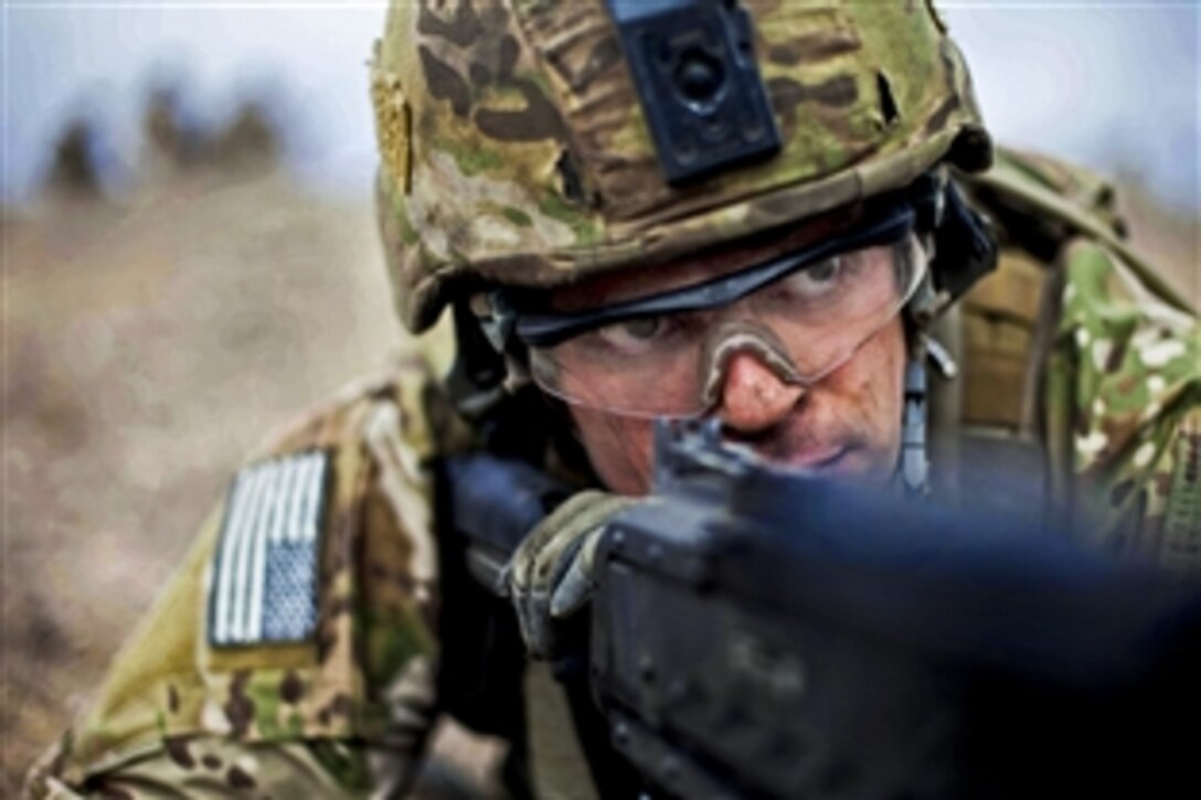 An Army Ranger keeps his sight on a target with an M249B automatic weapon during live-fire training on Camp Roberts, Calif., Jan. 30, 2014. 