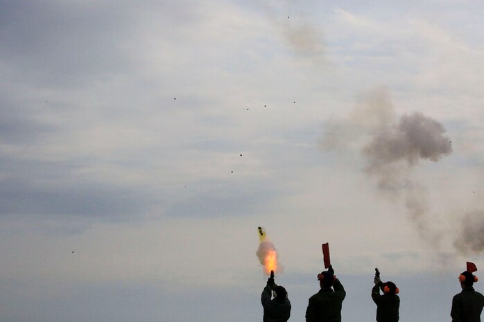 Japan Maritime Self-Defense Force aviators launch flares into the air as part of their mandatory, semi-annual Life-Saving Survival Training aboard Marine Corps Air Station Iwakuni, Japan, Jan. 28, 2014. In addition to the flare-gun, participants also shot off pencil-gun rounds, which is a smaller version of the flare-gun.