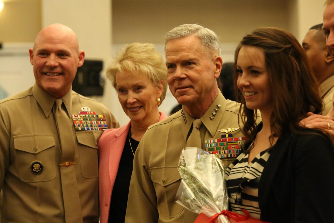 Sergeant Major of the Marine Corps Micheal Barrett, Bonnie Amos and her husband, the Commandant of the Marine Corps Gen. James Amos pose for a photo with Amanda Helms, the wife of Gunnery Sgt. Wesley Helms, during the Commandant of the Marine Corps Combined Awards Program ceremony at The Clubs of Quantico on Feb. 3, 2014. The wives of the spouses were recognized for the part they play in helping their spouses excel.