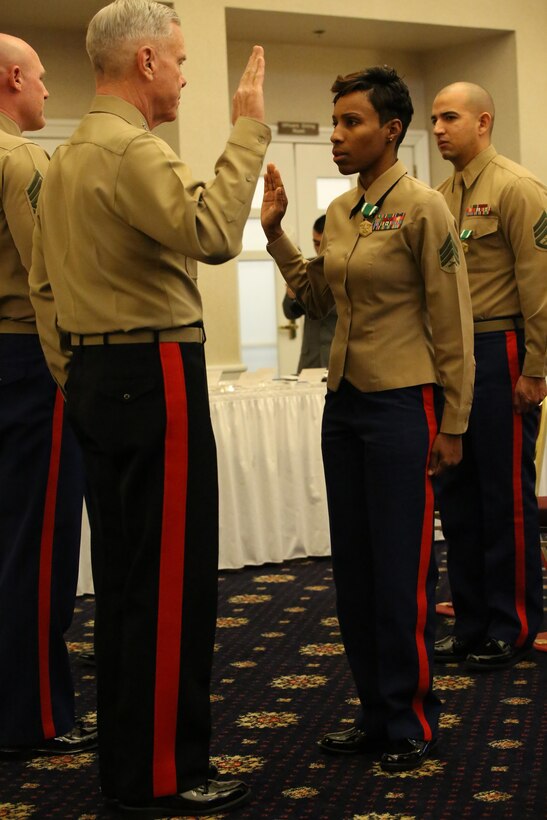 Commandant of the Marine Corps Gen. James Amos leads Sgt. Iasia Brown in the oath of enlistment during her meritorious promotion ceremony after she was selected as the Marine Corps Recruiter of the Year for the Commandant of the Marine Corps Combined Awards Program at The Clubs of Quantico on Feb. 3, 2014. Brown was meritoriously promoted to staff sergeant after her excellent performance last year. 