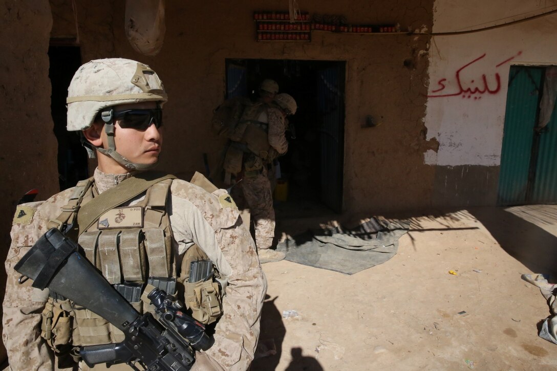 NAD ‘ALI DISTRICT, HELMAND PROVINCE, Afghanistan – Corporal Chan Zaw, a rifleman with Kilo Company, 3rd Battalion, 7th Marine Regiment, provides security while his fellow Marines search a local shop in the Qasim Bazaar, Jan. 17, 2014. Zaw, a 23-year-old native of Fresno, Calif., was also the mine sweeper in charge of finding improvised explosive devices in the bazaar. 