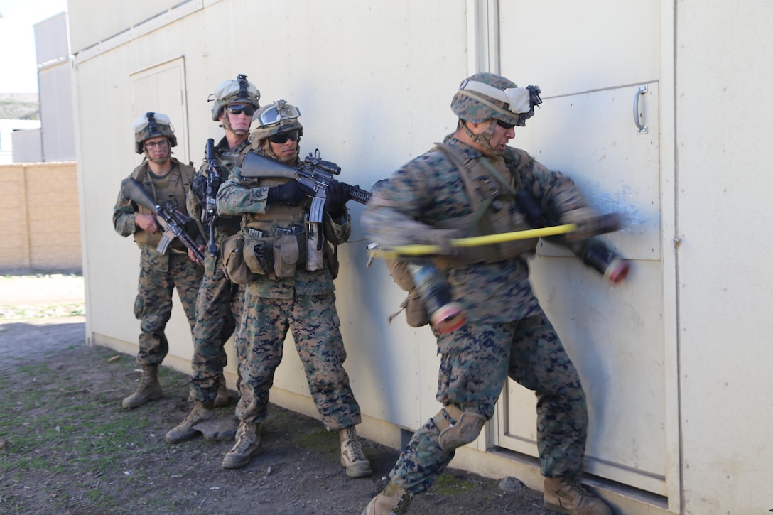 Marines with the 11th Marine Expeditionary Unit's ground combat element attempt to gain entry into a house through force as part of urban raid training here Feb. 5. This raid was the first of three different raids Marines conducted. This training evolution is one of many to prepare Marines for the MEU's scheduled deployment.
