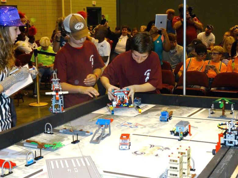 Team members from Vicksburg prepare their LEGO® robot for the “Nature’s Fury Challenge” Nov. 16 at the 2013 Central Mississippi FIRST® (For Inspiration and Recognition of Science and Technology) LEGO® League (FLL) at the Vicksburg Convention Center.  ERDC volunteers contributed to the success of this first regional qualifier competition.   