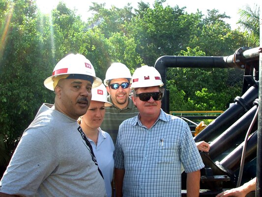 Members of the district dredge estimating team (left to right) are Rick Stallings, Jennifer Tyler, Tony Ledford, and Brian Blake. They are pictured here while on a site visit to observe the latest dredge dewatering technology being used on a project at Holmes Beach near Bradenton, Fla.