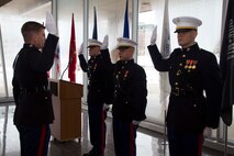 Capt. Chad Luebke administers the Oath of Office to newly commissioned Second Lieutenants Justin Hillebrand, Najieb Mahmoud and Kyle Davis at the Milwaukee County War Memorial Center, Jan. 24, 2014.