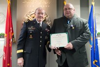 18th Chairman of the Joint Chiefs of Staff Gen. Martin E. Dempsey presents Army Pfc. (ret.) Mark A. Deville with a Silver Star, the nation's third highest military award, for his actions in Korea 30 years ago, at the Pentagon Jan. 28, 2014. DoD photo by Mass Communication Specialist 1st Class Daniel Hinton