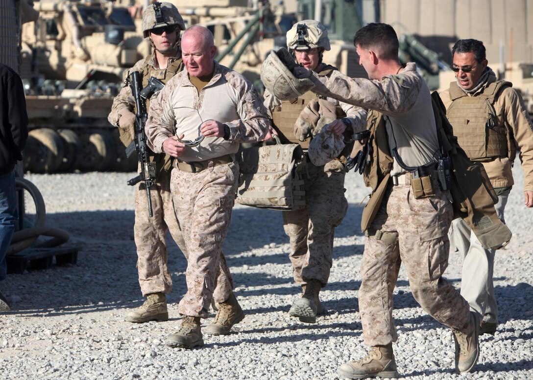 Major Gen. W. Lee Miller Jr., center, commanding general of Regional Command (Southwest), is welcomed aboard Forward Operating Base Nolay, Afghanistan, by Col. Christopher Douglas, right, team leader for Security Force Assistance Advisor Team 2-215, Jan. 28, 2014. Major Gen. Miller visited FOB Nolay for a meeting with officials of Afghan National Army 2nd Brigade, 215th Corps, and Afghan Uniformed Police about an ongoing operation being conducted in the Sangin Valley, Helmand province.
