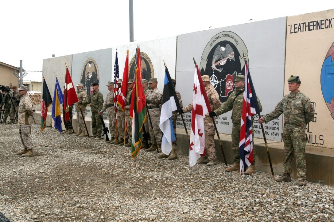 Marines and their coalition partners stand at parade rest prior to the start of the Regional Command (Southwest) transfer of authority ceremony aboard Camp Leatherneck, Afghanistan, Feb. 5, 2014. During the ceremony, II Marine Expeditionary Force (Forward) transferred command and control of coalition operations in Helmand and Nimroz provinces to Marine Expeditionary Brigade – Afghanistan.