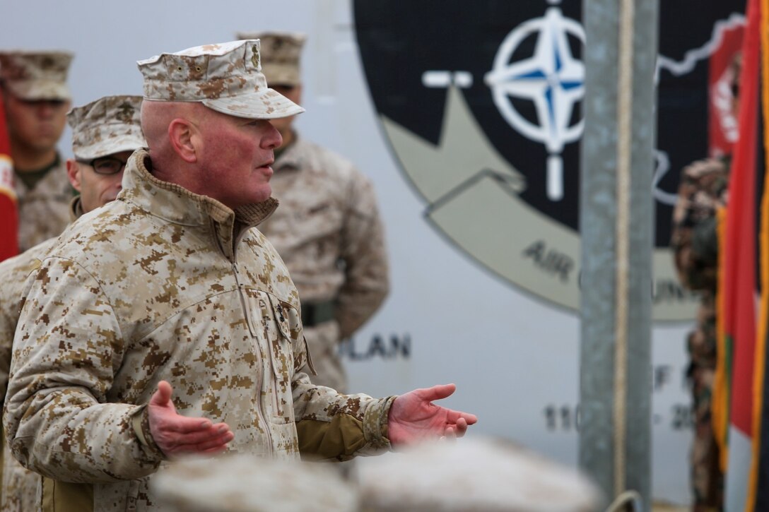 U.S. Marine Corps Maj. Gen. W. Lee Miller, Jr., left, Commanding General of the II Marine Expeditionary Force (MEF) Forward gives a speech to U.S. Marines, Sailors, Soldiers, and ISAF military personel during a Transfer of Authority ceremony on Camp Leatherneck, Helmand province, Afghanistan, Feb. 5, 2014. Marine Expeditionary Brigade Afghanistan officially relieved II MEF (FWD) and took over their responsibilities for Regional Command (Southwest). (Official Marine Corps Photo by Lance Cpl. Darien J. Bjorndal/Released)