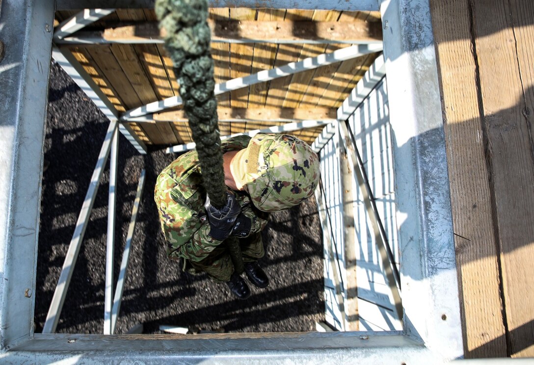 A soldier from the Japan Ground Self-Defense Force fast ropes down a 30-foot tower while conducting fast-rope training with 1st Reconnaissance Battalion, 1st Marine Division, during Exercise Iron Fist 2014 aboard Camp Pendleton, Calif., Feb. 5, 2014. Iron Fist is an amphibious exercise that brings together Marines and sailors from the 15th Marine Expeditionary Unit, other I Marine Expeditionary Force units, and soldiers from the JGSDF, to promote military interoperability and hone individual and small-unit skills through challenging, complex and realistic training. (U.S. Marine Corps photo by Cpl. Emmanuel Ramos/Released)  