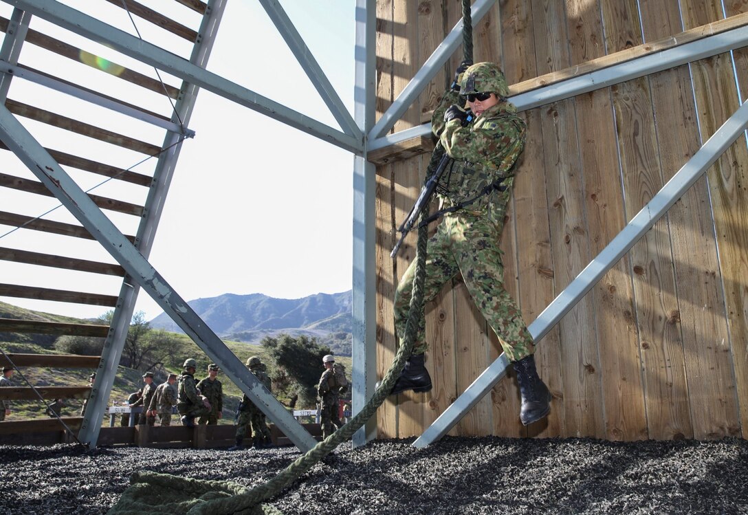 A soldier from the Japan Ground Self-Defense Force, fast ropes down a 30-foot tower while conducting fast-rope training with 1st Reconnaissance Battalion, 1st Marine Division, during Exercise Iron Fist 2014 aboard Camp Pendleton, Calif., Feb. 5, 2014. Iron Fist is an amphibious exercise that brings together Marines and sailors from the 15th Marine Expeditionary Unit, other I Marine Expeditionary Force units, and soldiers from the JGSDF, to promote military interoperability and hone individual and small-unit skills through challenging, complex and realistic training. (U.S. Marine Corps photo by Cpl. Emmanuel Ramos/Released)