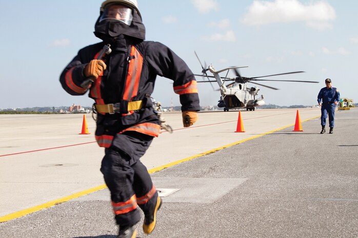 Ryuta Arashiro runs toward the finish line during a friendly competition between firefighters from Ginowan City Fire Department and Marine aircraft  rescue and firefighting specialists with Headquarters and Headquarters Squadron and Marine Wing Support Squadron 172 Jan. 31 at Marine Corps Air Station Futenma. The firefighters spent the day competing against each other in a series of timed events based around daily firefighting skills. Arashiro is a firefighter with the Ginowan City Fire Department. H&HS is with MCAS Futenma, Marine Corps Base Camp Smedley D. Butler, Marine Corps Installations Pacific. MWSS-172 is with, Marine Wing Support Group 17, 1st Marine Aircraft Wing, III Marine Expeditionary Force. Photo by Lance Cpl. Stephen D. Himes