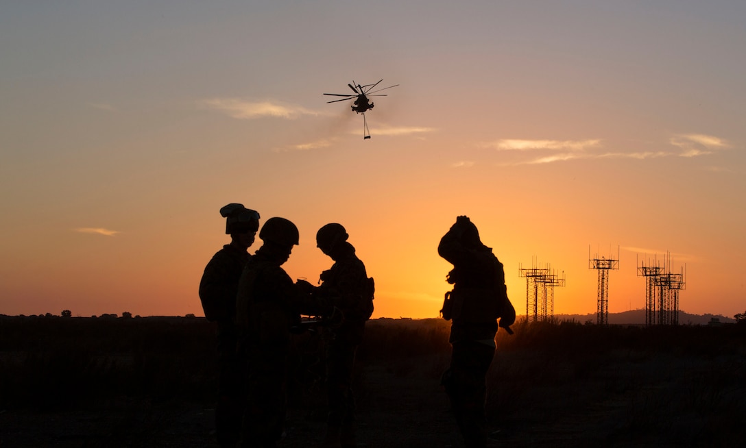 Marines with Combat Logistics Battalion (CLB) 11, wait for a CH-53 Super Stallion with Marine Medium Tiltrotor Squadron (VMM) 163 to drop off simulated cargo aboard Marine Corps Air Station Miramar, Calif., Feb. 5. CLB-11 trained with VMM-163 to become more proficient as a Helicopter Support Team.  