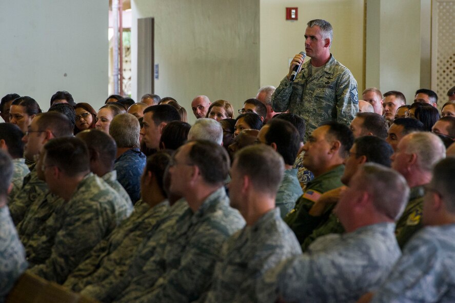 An Airman asks a question during a Commander's Call for all Pacific Air Forces personnel held by General Hawk Carlisle, PACAF commander, Feb. 4, 2014, at the Hickam Officers Club on Joint Base Pearl Harbor-Hickam, Hawaii. During the call, Carlisle highlighted historic military leaders who have used innovation and leadership to accomplish extraordinary tasks – a trait he encouraged current Airmen to adopt in order to overcome current fiscal constraints. (U.S. Air Force photo by Staff Sgt. Nathan Allen)